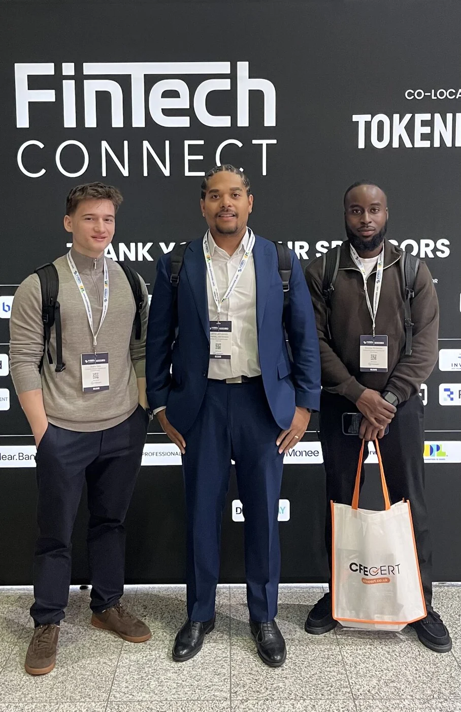 Members of the CapitalPay UK team beside the FinTech Connect event wall